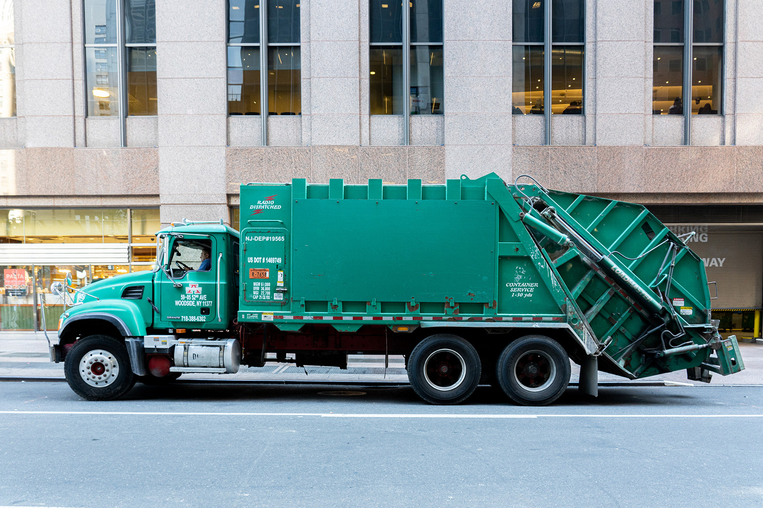 Garbage truck parked on a city street